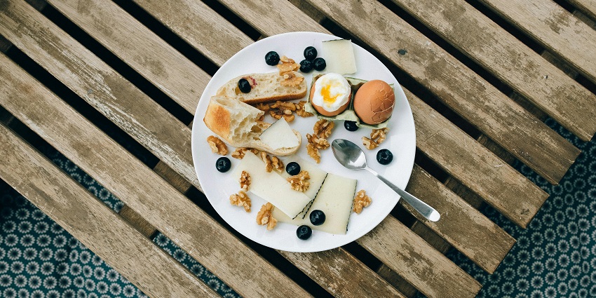 Image of food in a white plate - enjoy Swiss cuisine, fondue, pastries, and scenic views