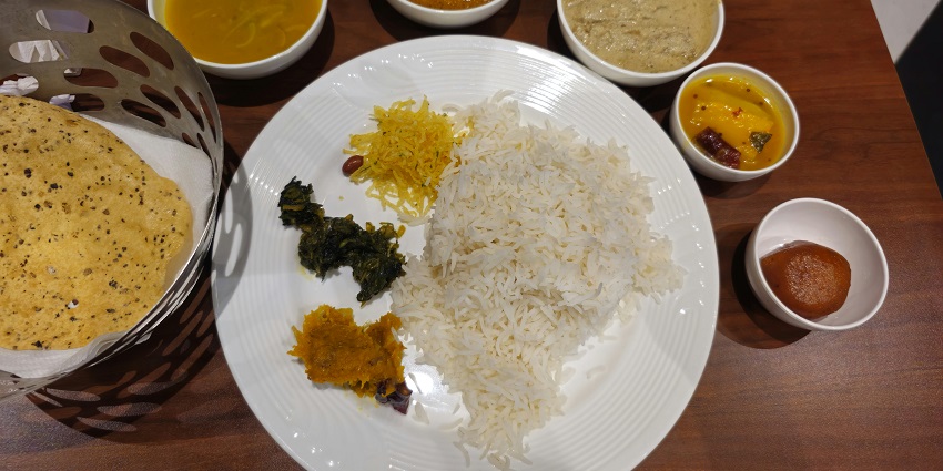 An image of a traditional Tibetan meal served with momos, thukpa, and other local dishes