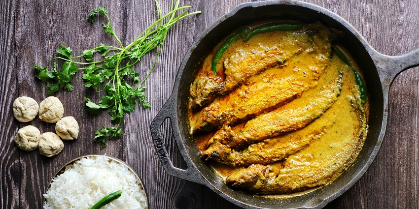 A picture of Spicy fish curry served on a plate near the Aircraft Museum, Kolkata.