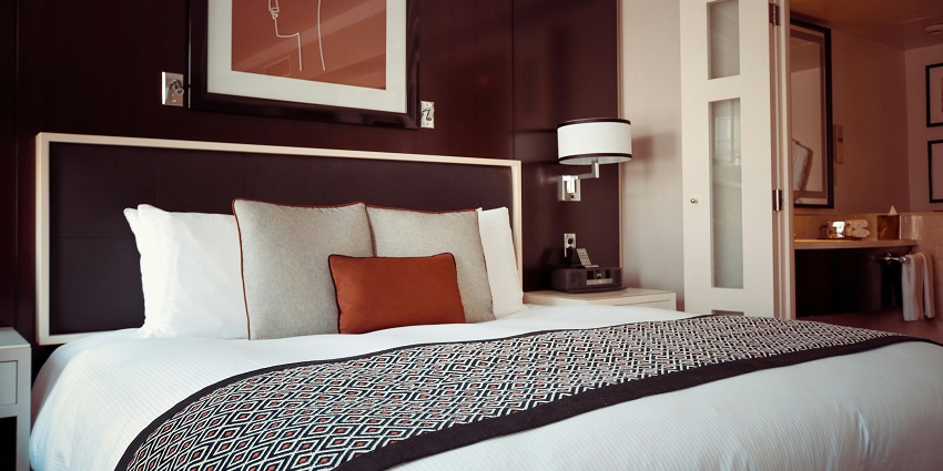 A picture of a hotel room at a hotel in West Bengal with all the basic amenities.