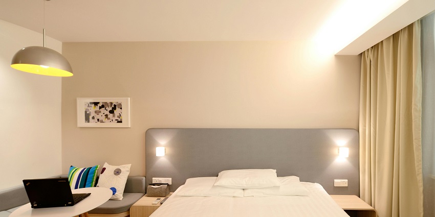 A picture of a hotel room with all the basic amenities