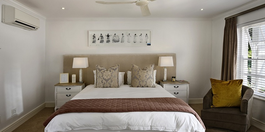 Cosy bedroom with modern interior design, featuring a comfortable bed and soft lighting