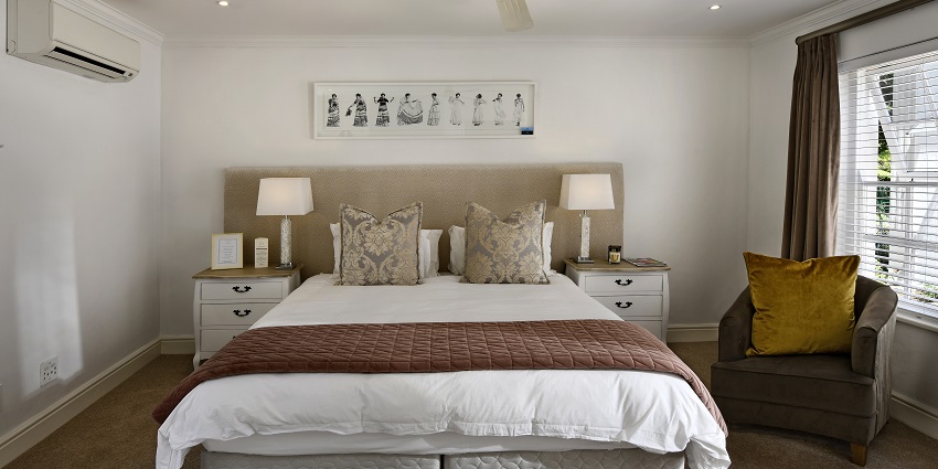 A glimpse of stylish bedroom with a large bed, minimalist decor, and natural light.