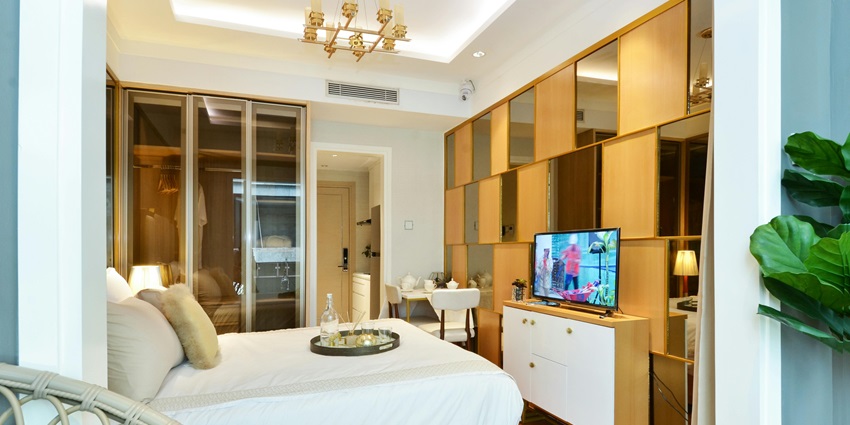 Image of a hotel room - White Bed Linen Near White Wooden Cabinet