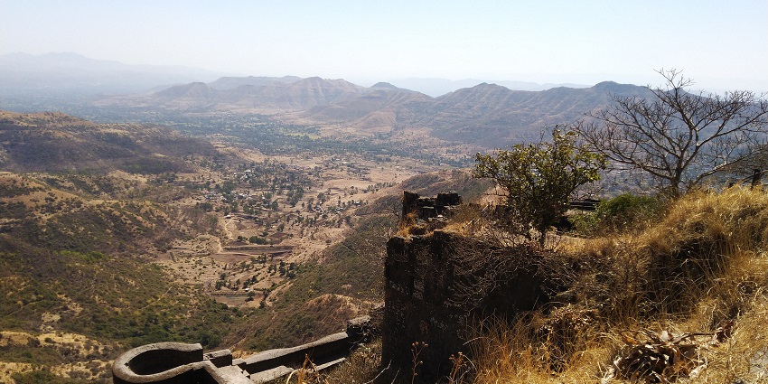 An aerial view of the Kalyan Darwaja in Sinhgad fort surrounded by the valleys