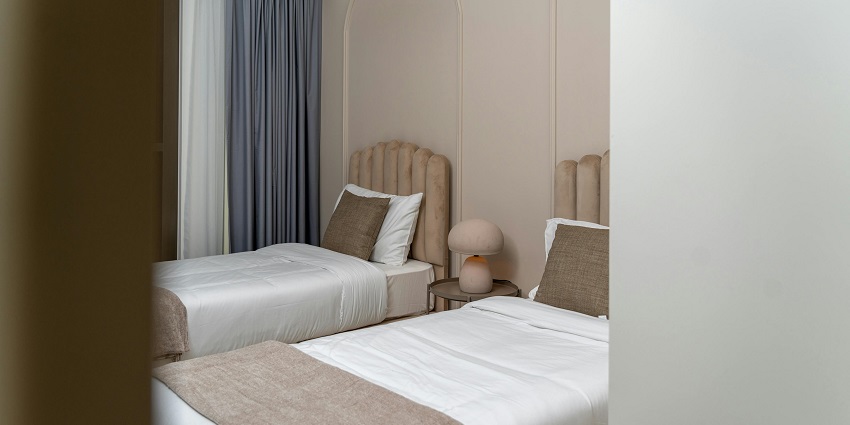 Image from the inside of the hotel room with cosy bed and beautiful settings