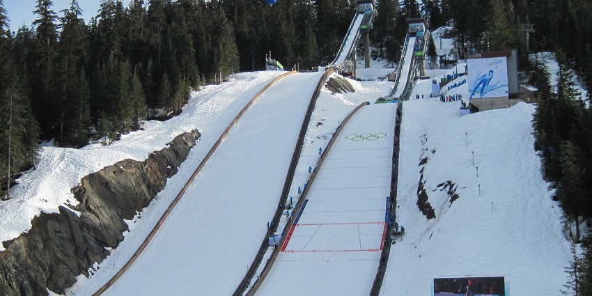 The Ski Jumping Center at the Whistler Olympic Park with several people watching
