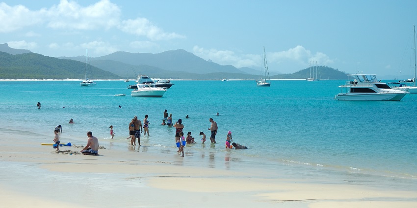 People enjoying in water at Whitehaven Beach, one of the beaches in Queensland.