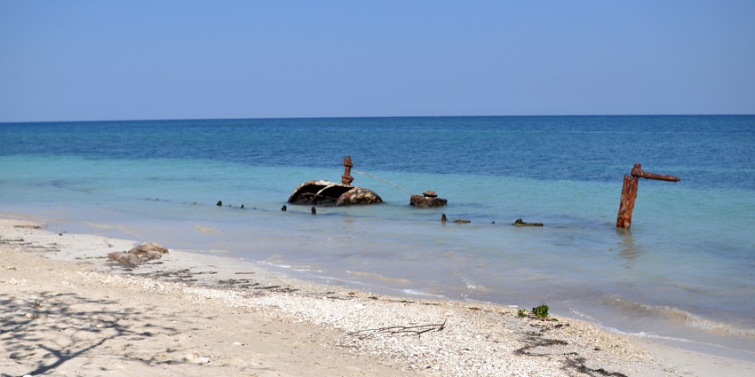A picture of a beautiful beach with white sand and blue waters