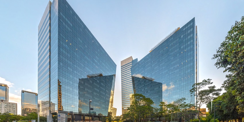 A picture of a corporate building in Kolkata with a small garden area in front of it