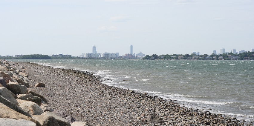 View of Wollaston Beach with calm waters and a peaceful shoreline in Quincy, Massachusetts
