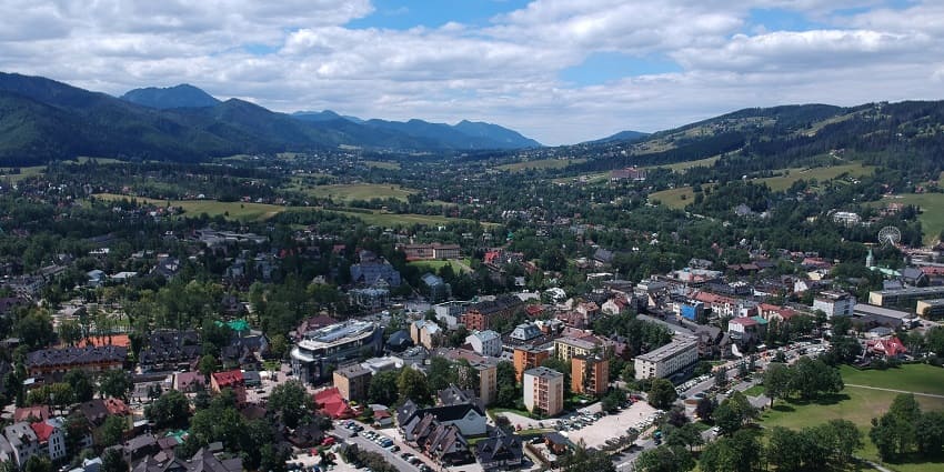 Zakopane from the top with vibrant buildings surrounded by greenery and distant hills
