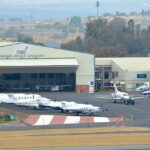 An aerial picture of an airport in South Africa with multiple aircrafts lined up