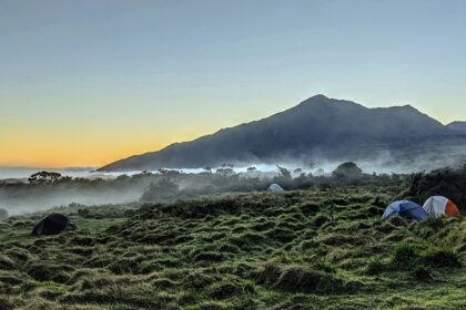 A panoramic view of Haleakala National Park with volcanic landscape and clear skies.