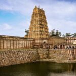 An image of Vakrakaliamman Temple featuring carved towers adorned with colourful statues.