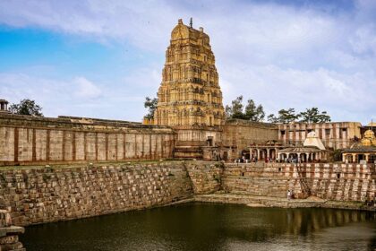 An image of Vakrakaliamman Temple featuring carved towers adorned with colourful statues.