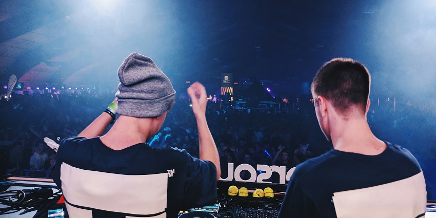 Two DJs using sound mixers to produce new music showcasing Accra Ghana nightlife.