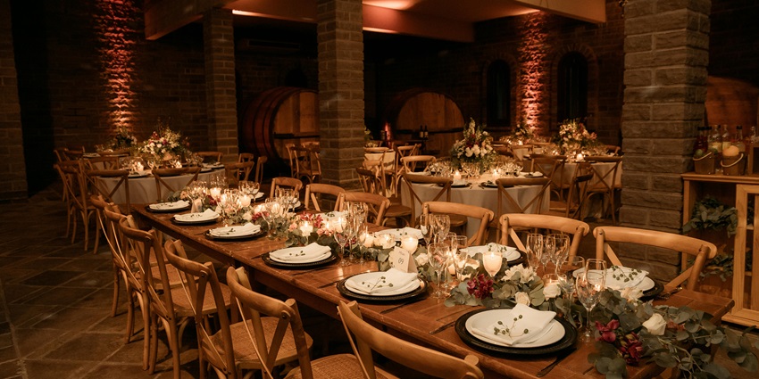 Restaurant in the winery with wooden-themed tables and chairs decorated with flowers