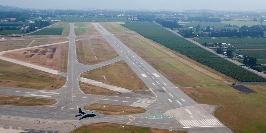 A clear view of the runway at Abbotsford International Airport under a bright sky.