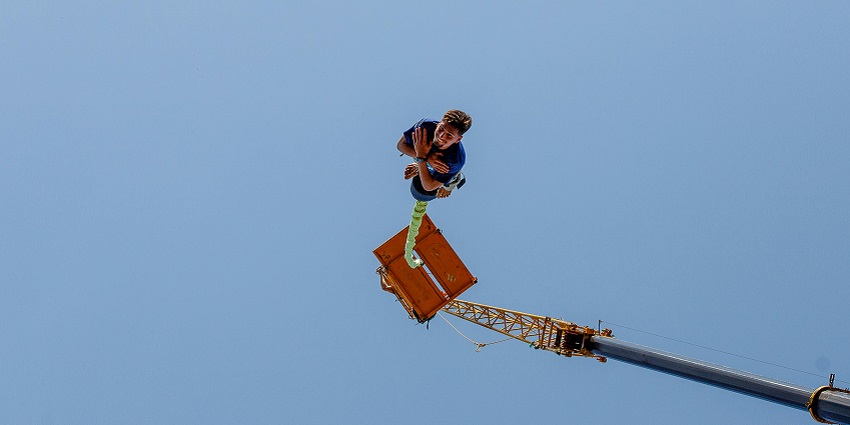 A man performing and enjoying a bungee jumping adventure in Odisha from a crane