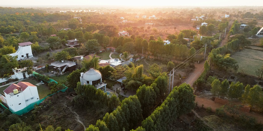 A beautiful bird eye view of a village surrounded by green trees in Chhattisgarh