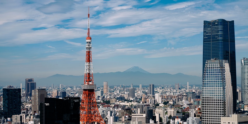 Image of Tokyo tower surrounded by high buildings during day time view