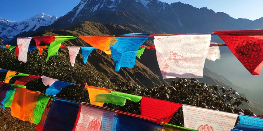 A colourful buddhist flag on the mountains in in Nepal with picturesque view