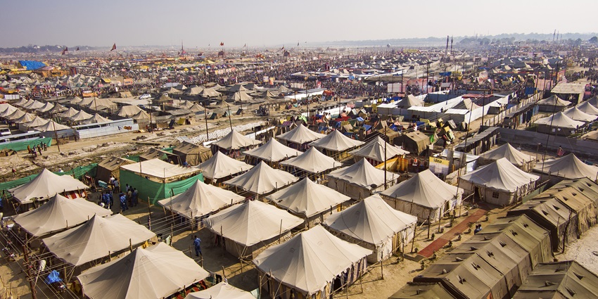 An aerial view of the Maha Kumbh Mela with various white coloured tents in the day.