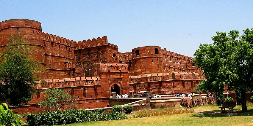 Front view of Agra Fort, made of red brick in Agra, as mentioned in the UP travel guide.