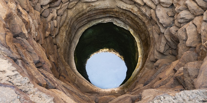 Ancient well in Khaybar, surrounded by desert landscapes and history