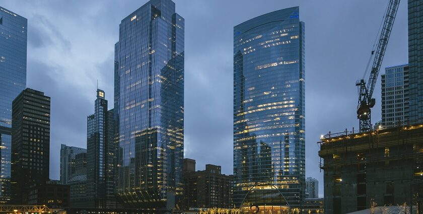 A view of the Chicago skyline at dusk with buildings and lights under a colourful sky.