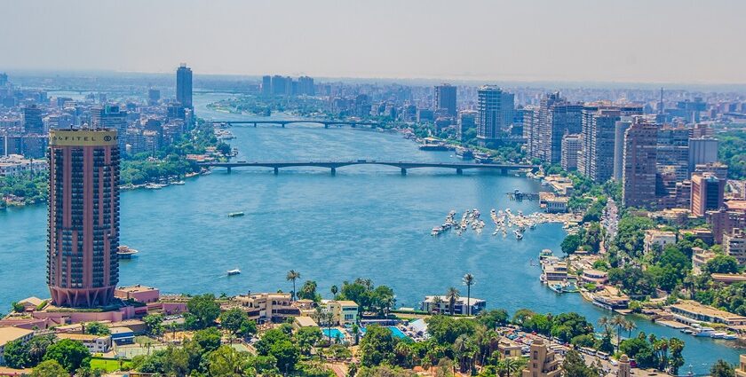 An aerial view of Egyptian city showing tall buildings, blue waters and a bridge