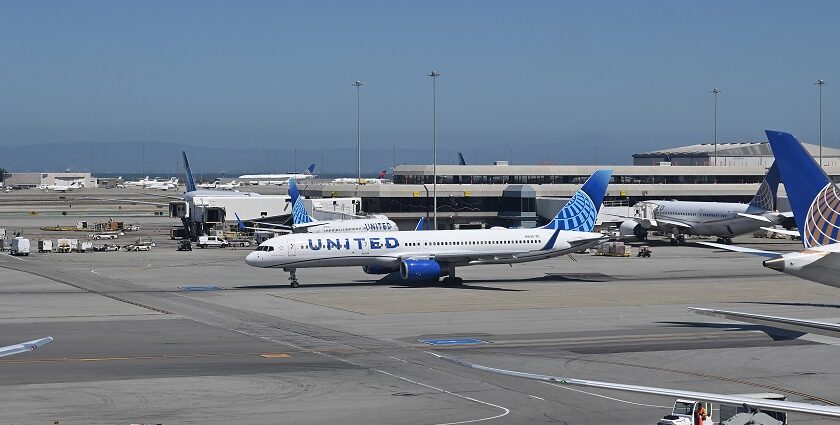 San Francisco International Airport illuminated at night with terminal lights and parked aircraft.