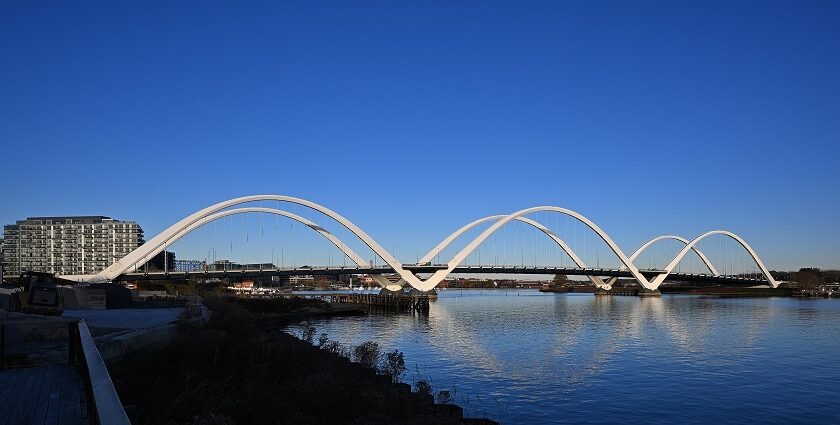 A view of Frederick Douglass Memorial Bridge in Washington, D.C., at sunset with a clear sky