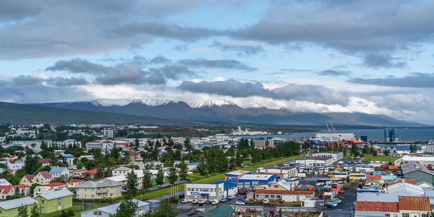 An image of Akureyri, a beautiful destination in Iceland with mountains and waterfront.