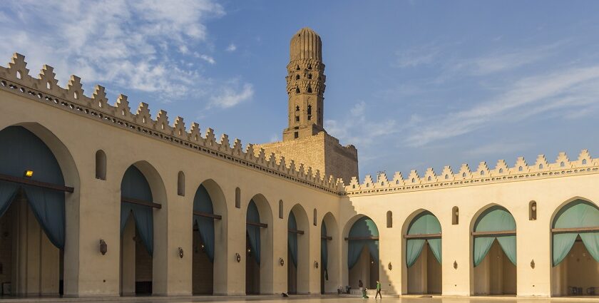 Inside view of the Al-Hakim Mosque showcasing a long hall surrounded by the buildings