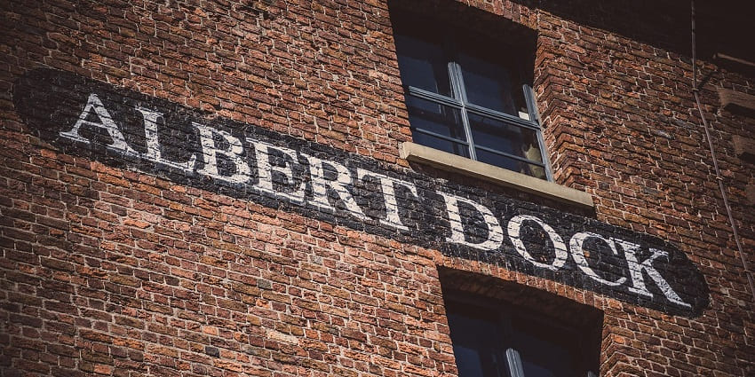 An image of a brick building with a sign reading "Albert Dock" above a window in Liverpool.