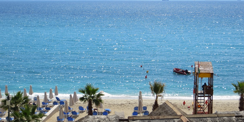 Image of picturesque Alimos beach with clear blue water under blue sky