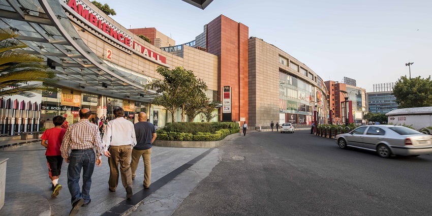 Visitors entering Ambience Mall, a top shopping destination near De Adventure Park.
