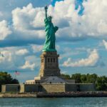 Statue of Liberty against Fluffy White Clouds - America travel guide takes you through the diverse landscapes