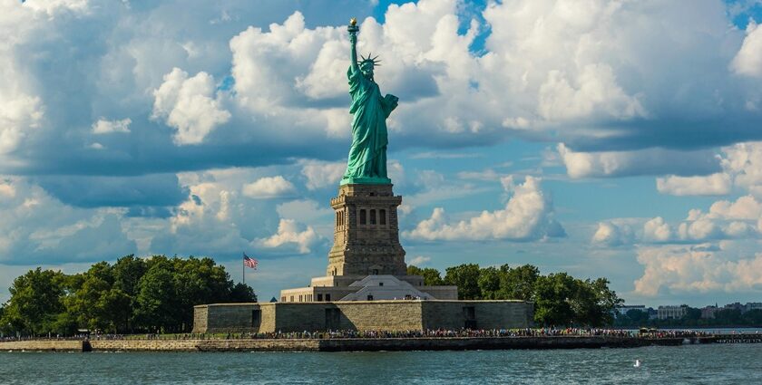 Statue of Liberty against Fluffy White Clouds - America travel guide takes you through the diverse landscapes