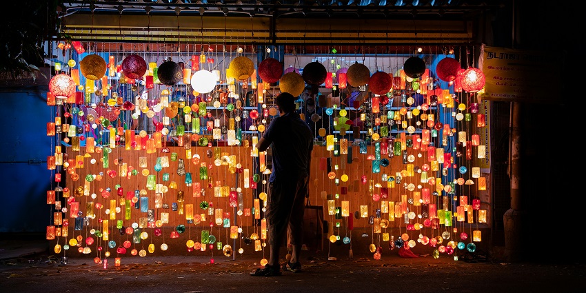 shop through the lively street of Aminabad market at night