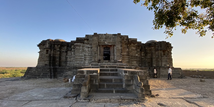 Stone Anandeshwar Temple at Lasur, with open‑roof hall and carved pillars