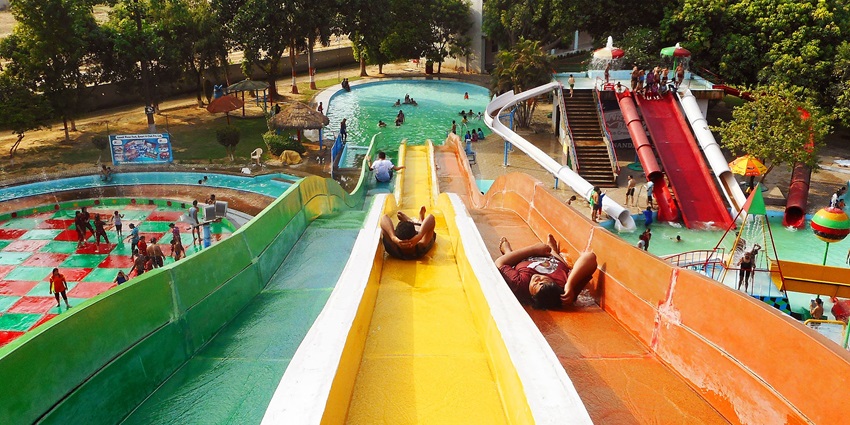 A glimpse of people enjoying thrilling water rides at the famous Anandi Water Park.