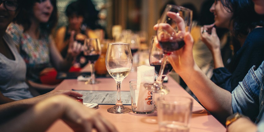 An image of Anonymous Bar with masked bartenders serving unique, cryptic cocktails