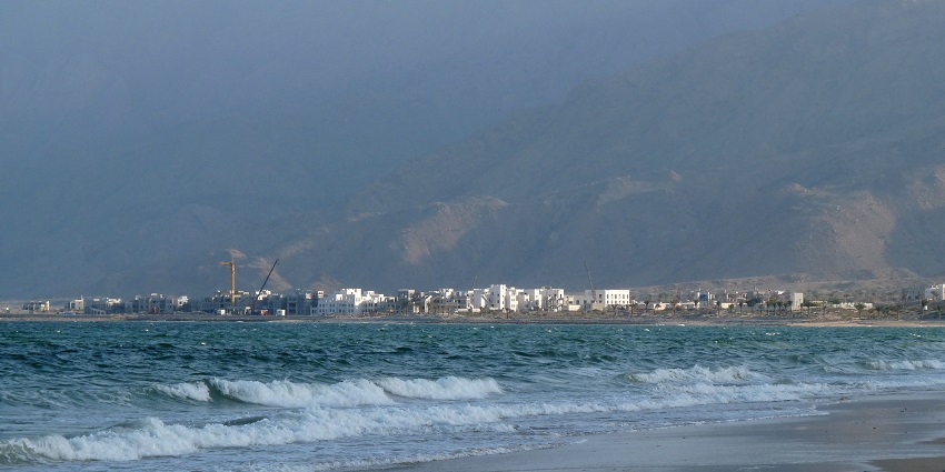 Scenic coastal area with pleasant waves and sandy shores at one of the Oman beaches.