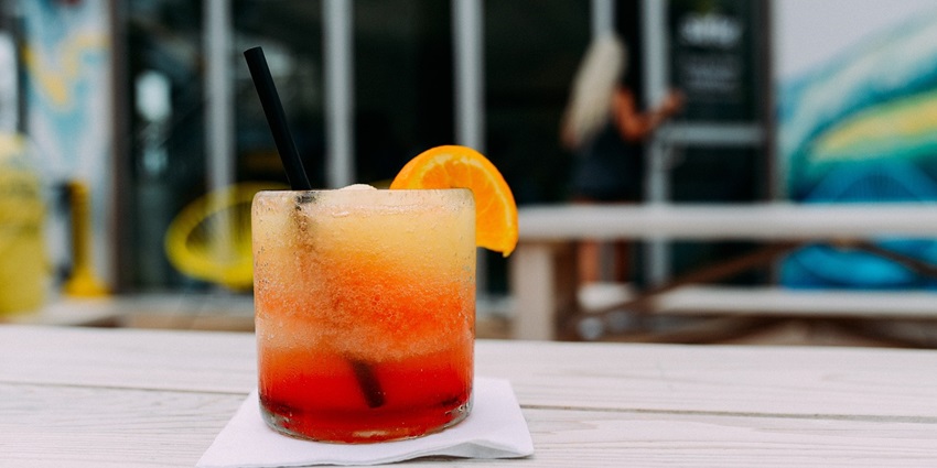 Ice mocktail with juice and a piece of orange served with a straw, displaying Dar es salaam nightlife.