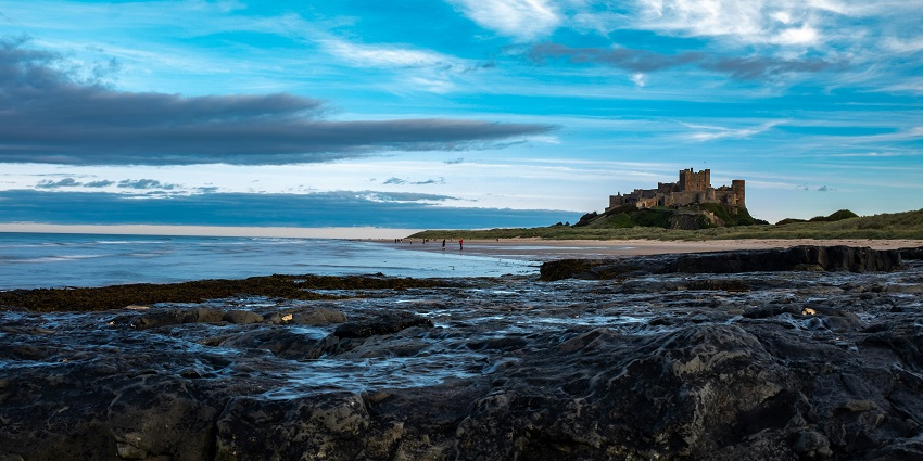 Bamburgh Beach, a scenic beach in Northumberland with views of Bamburgh Castle.