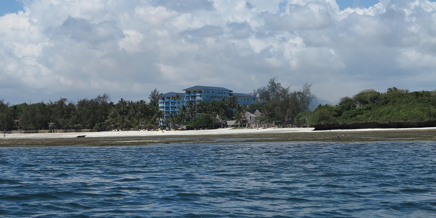 A distant view of the Bamburi Beach with deep blue-coloured water surrounding it