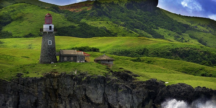 Batanes - rolling green hills, traditional stone houses, breathtaking serene landscapes.